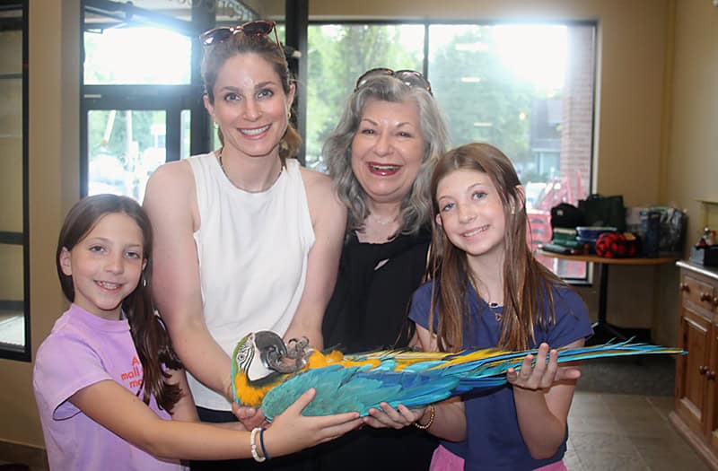 Image of the parrot Mr. Baby held by Sheila Gould and her family.